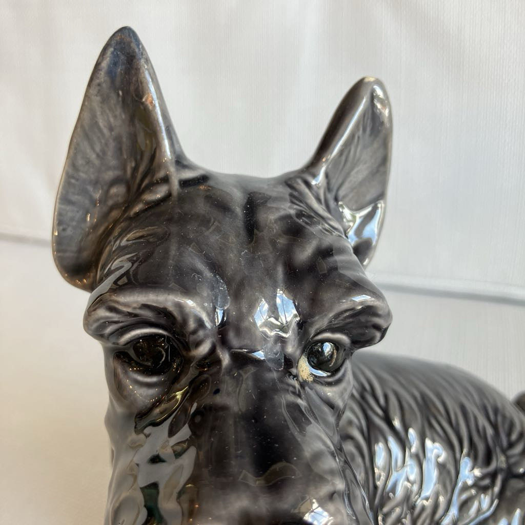 Close-up of a ceramic dog figurine with a blurred background