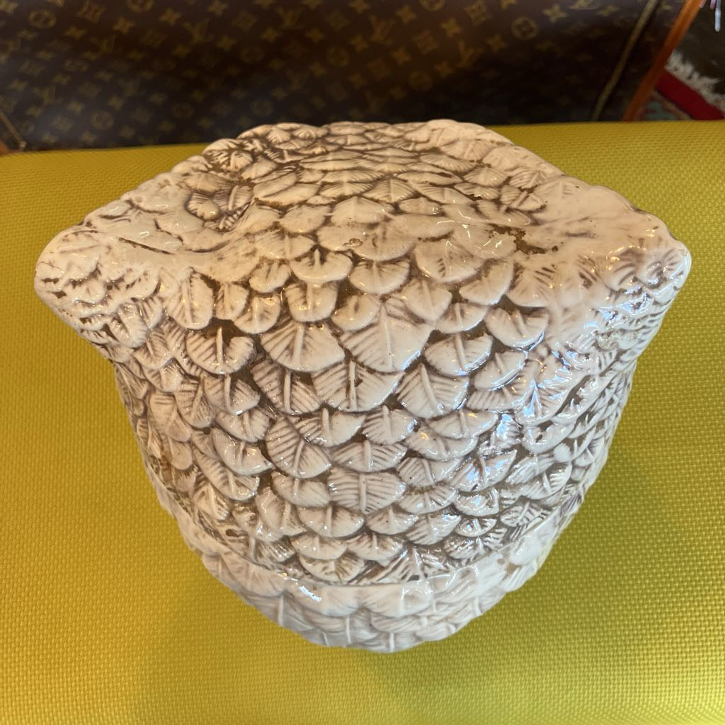 Decorative stone with leaf pattern on a yellow surface