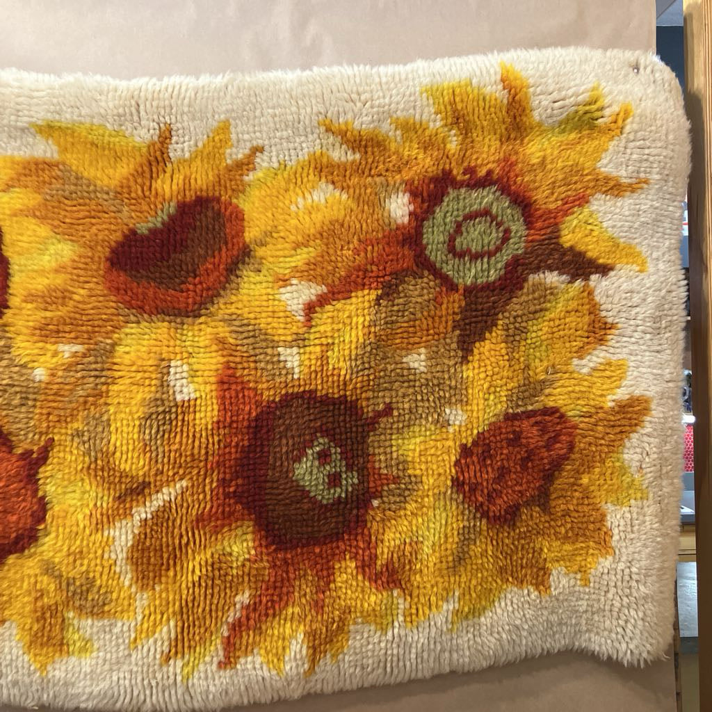 Decorative tapestry with sunflower pattern on a neutral background