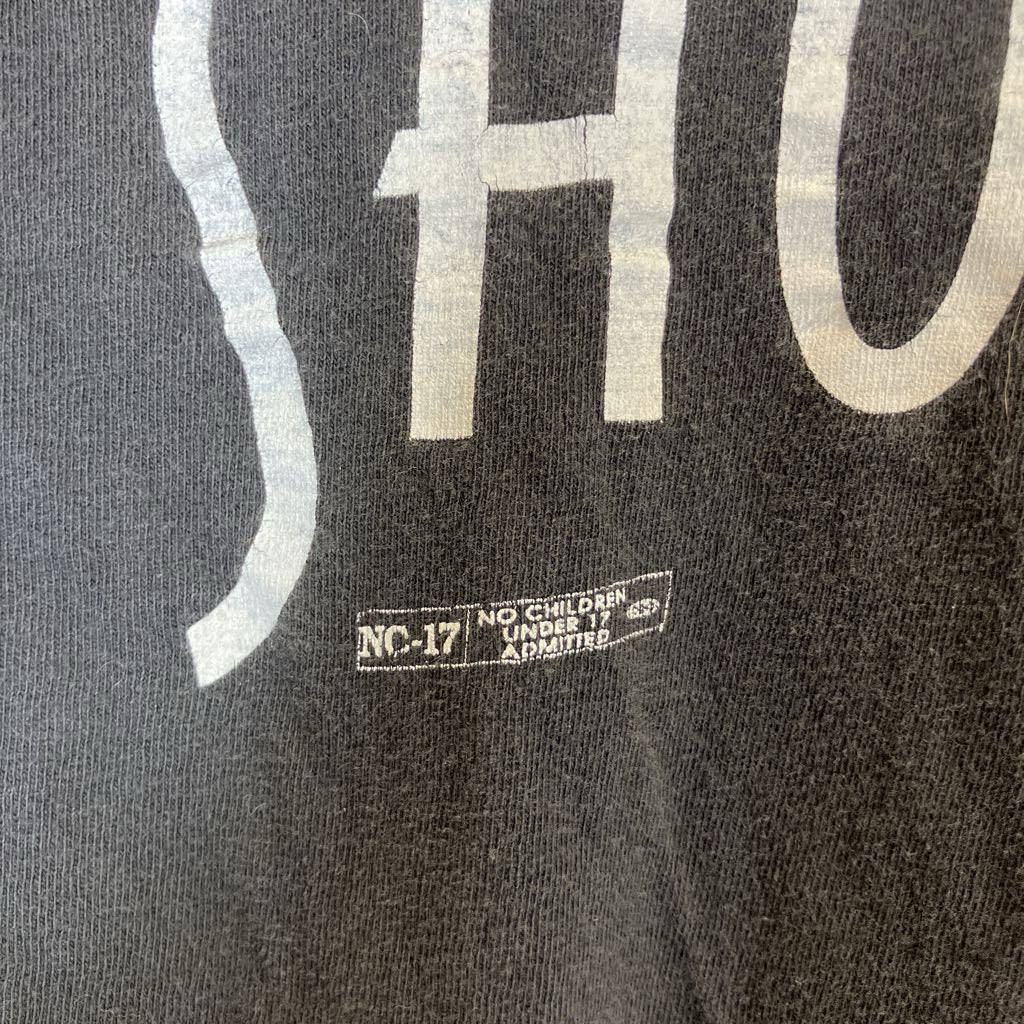 Black shirt with white text and NC-17 rating label