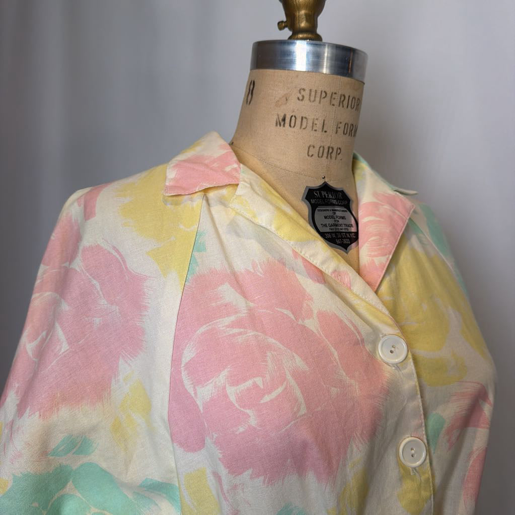 Pastel floral shirt on a mannequin with a gray background