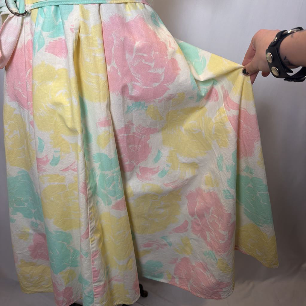 Pastel floral dress held up against a white background
