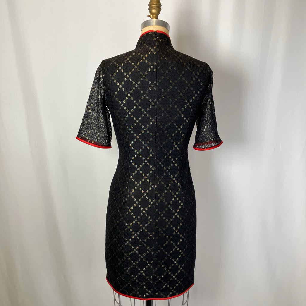 Black patterned dress on a mannequin against a white background