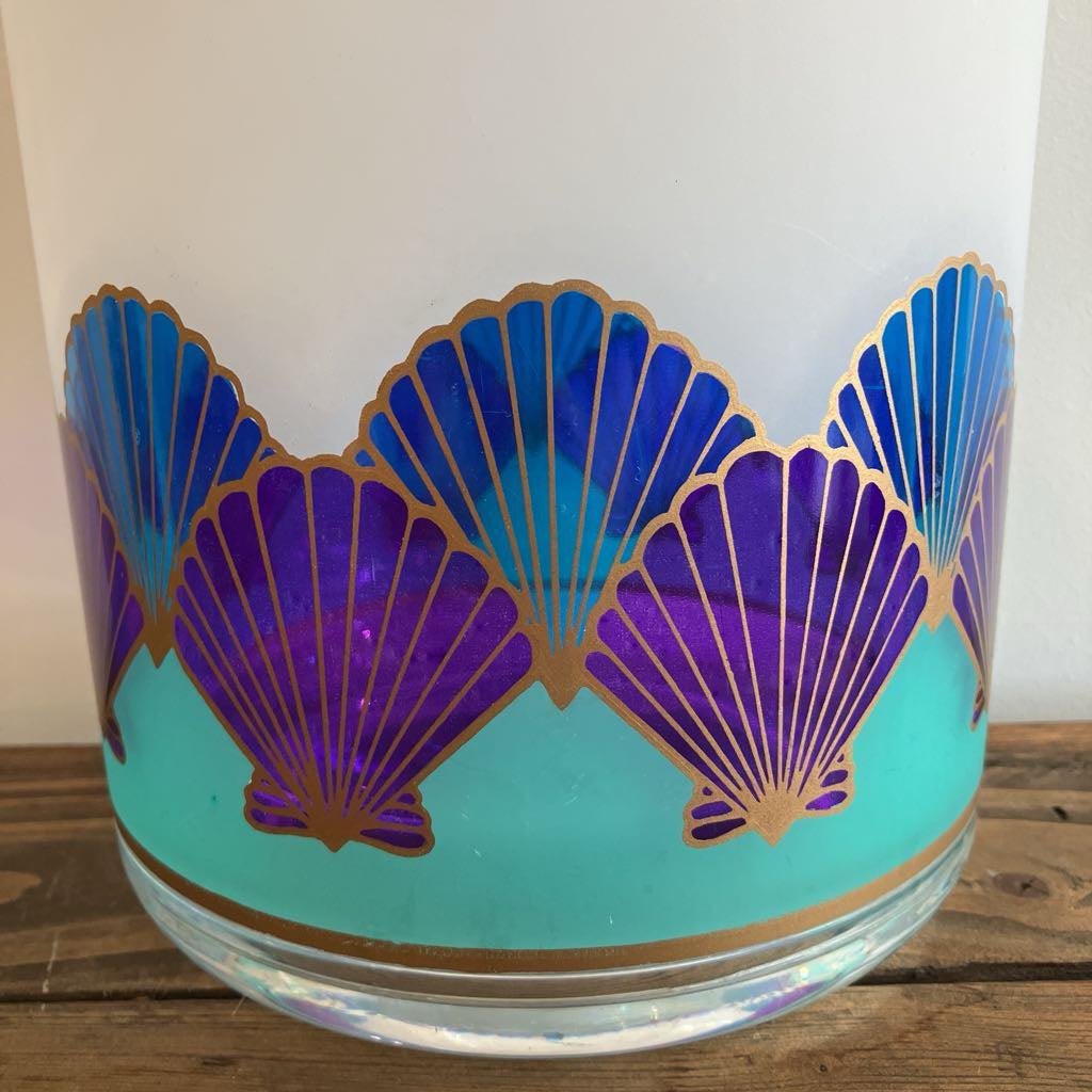 Plastic vase with shell pattern on a wooden surface