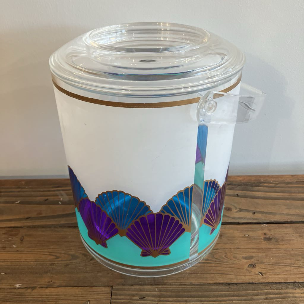 Clear plastic tumbler with purple and blue shell design on a wooden surface