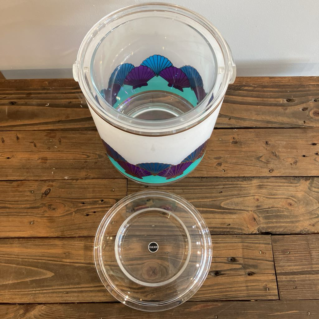Clear plastic container with a colorful interior design on a wooden surface