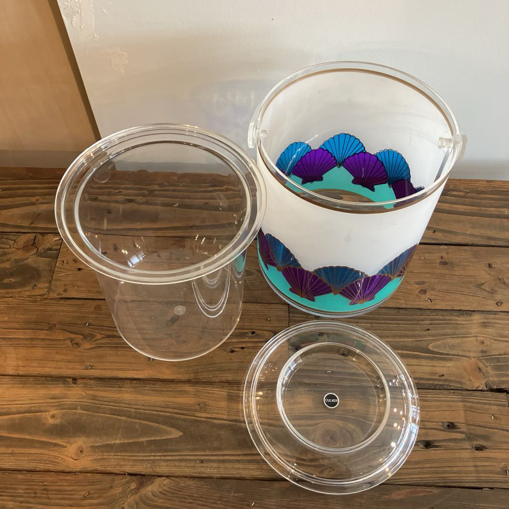 Clear plastic containers with colorful interior design on a wooden surface