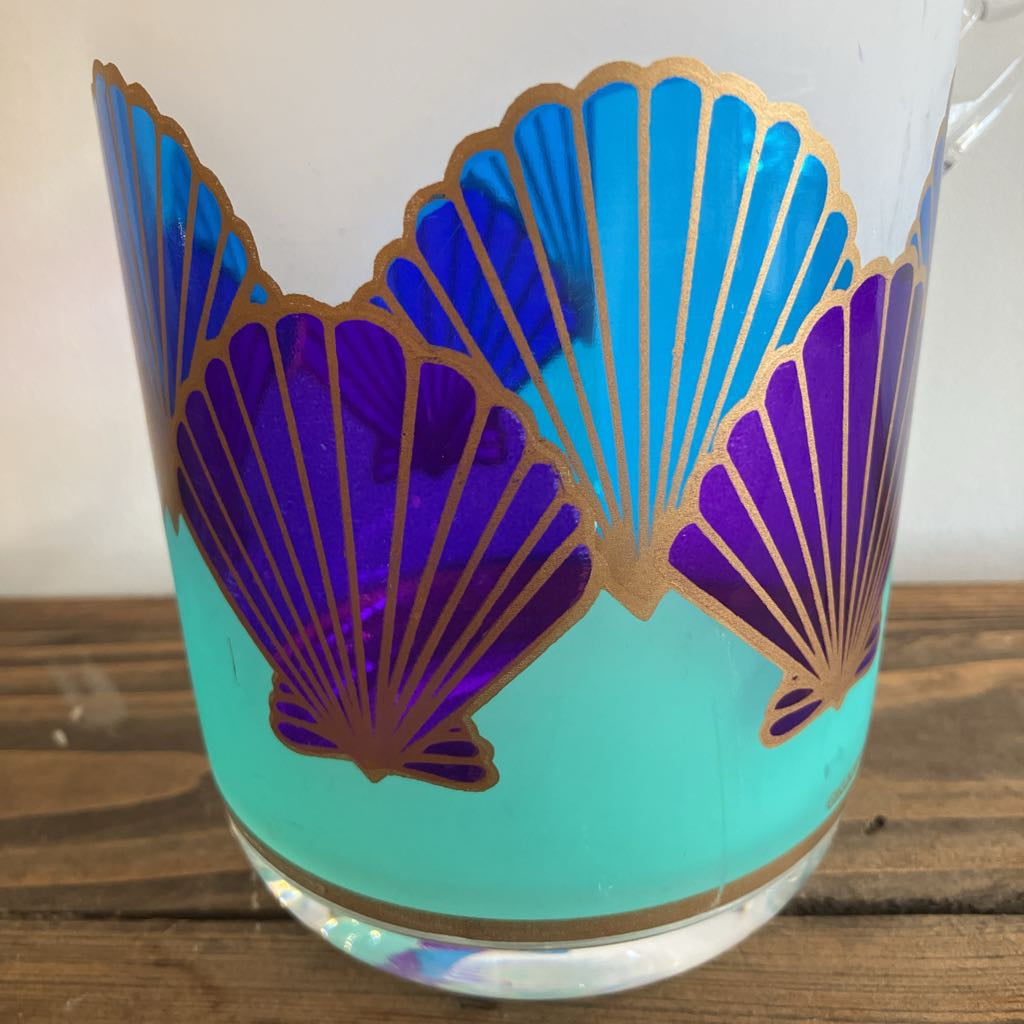 Plastic with blue and purple shell design on a wooden surface
