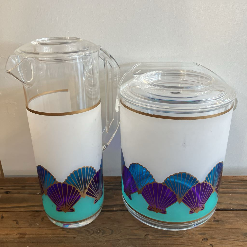 Two plastic containers with decorative shell patterns on a wooden surface.