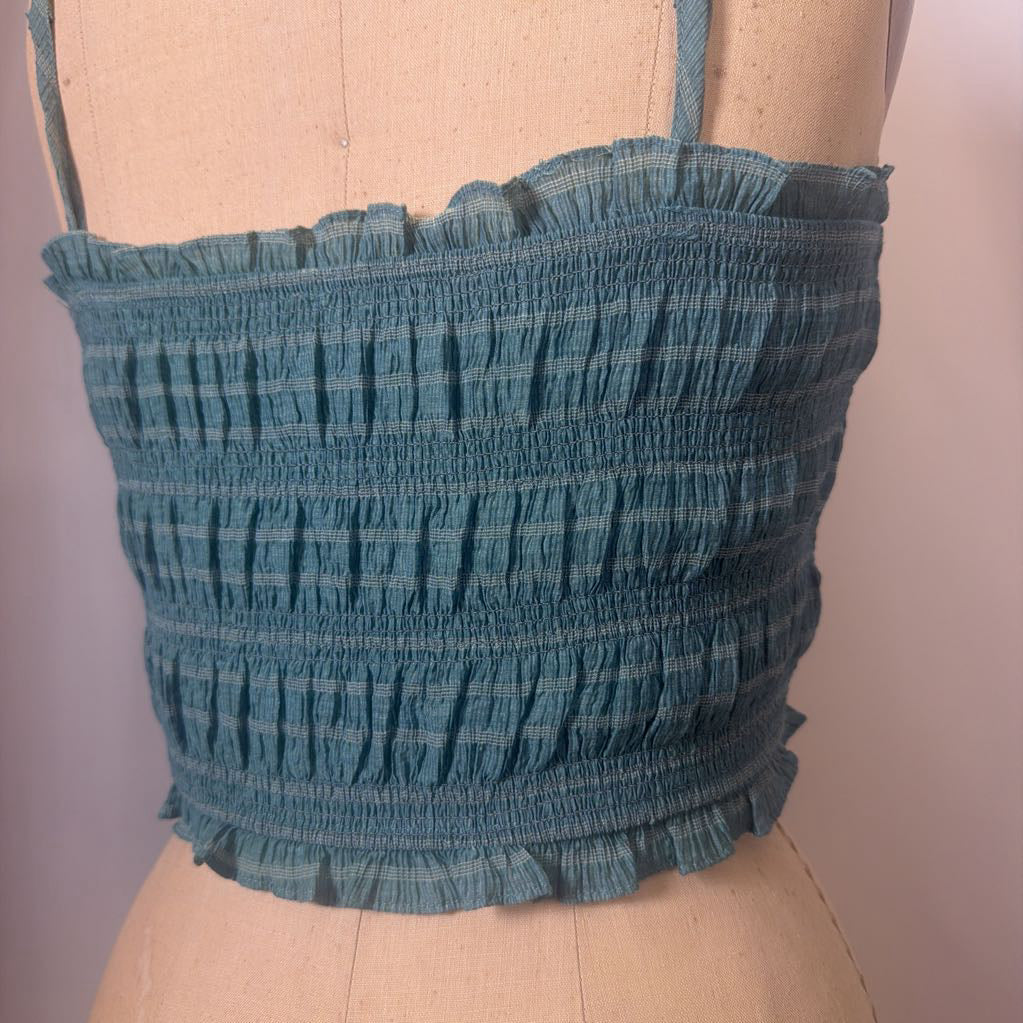 Blue patterned top on a mannequin against a plain background