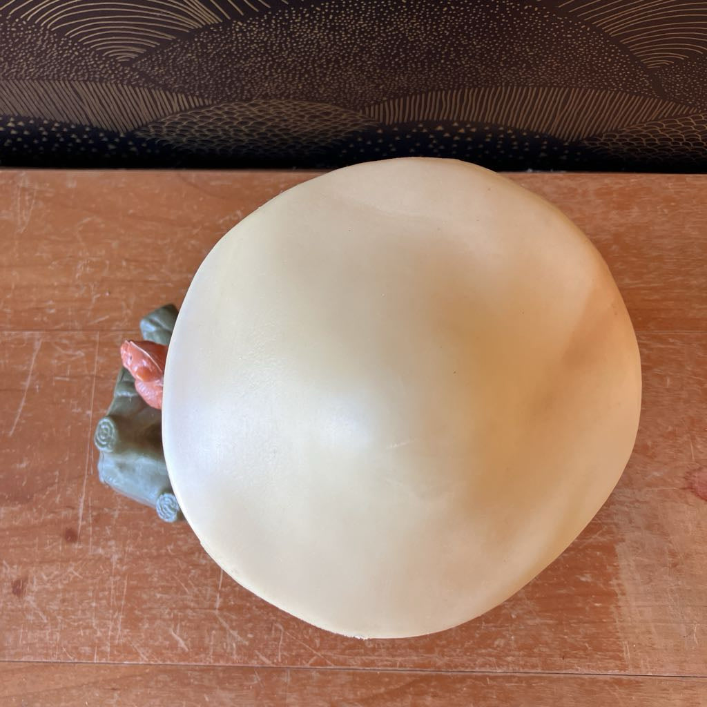 Aerial view of a mushroom figurine on a wooden surface.