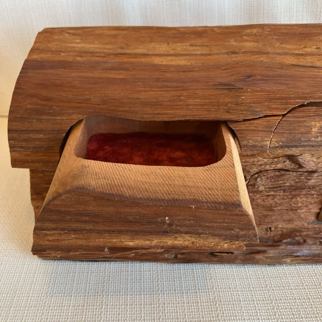 Wooden box with a rectangular cutout on a textured surface