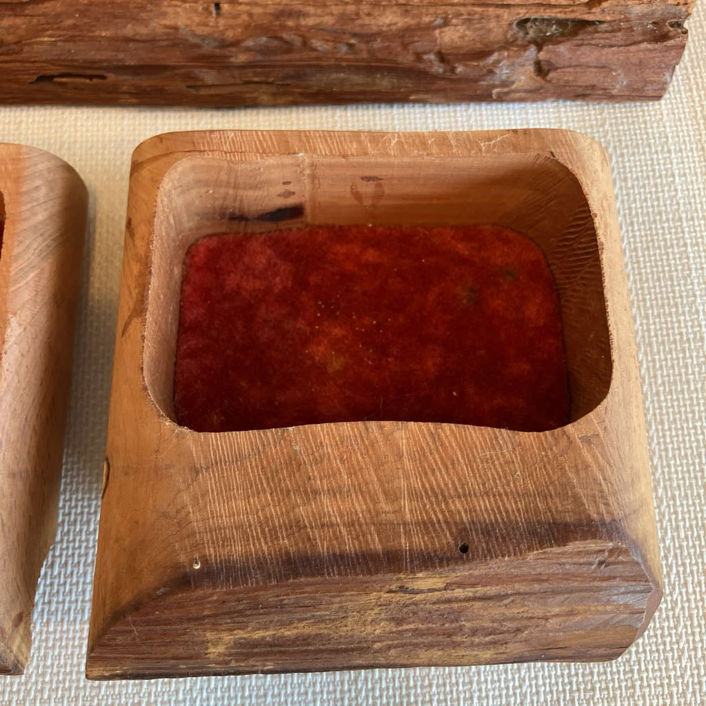 Wooden box with a red interior on a textured surface