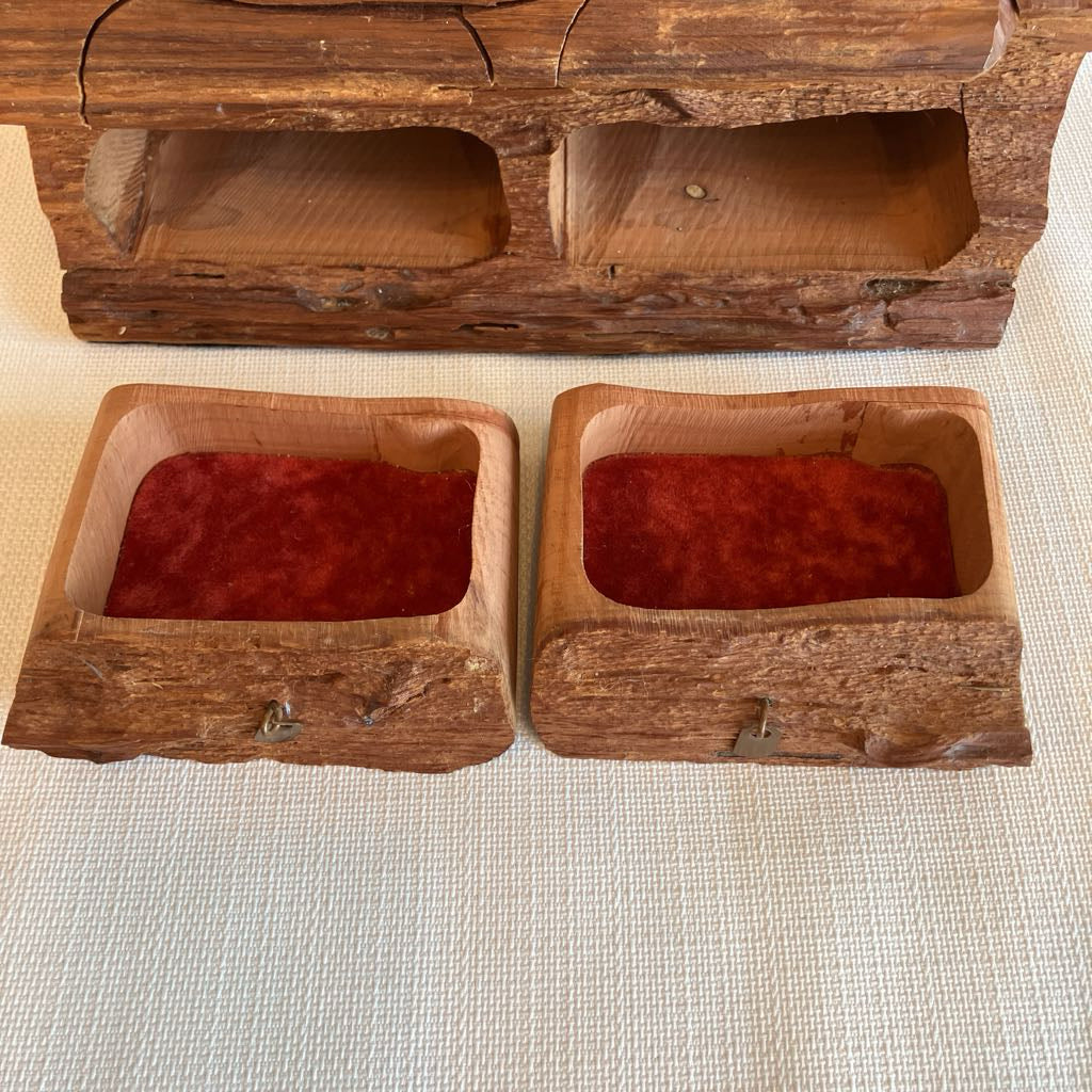 Two wooden boxes with red contents on a textured surface