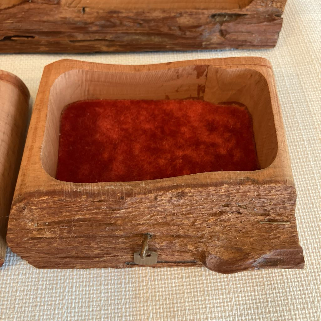 Wooden box with a red interior on a textured surface