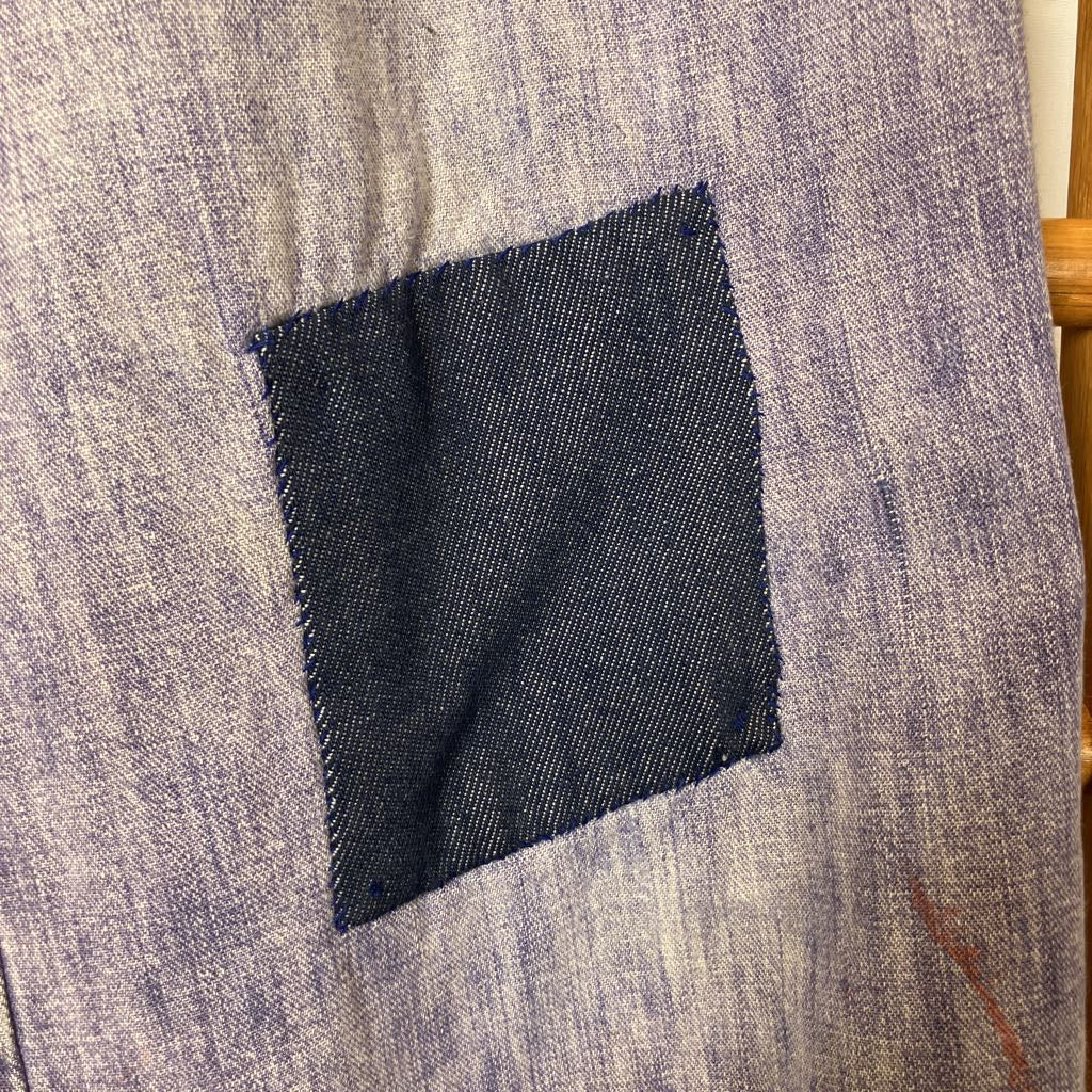 Close-up of a gray fabric with a dark blue patch