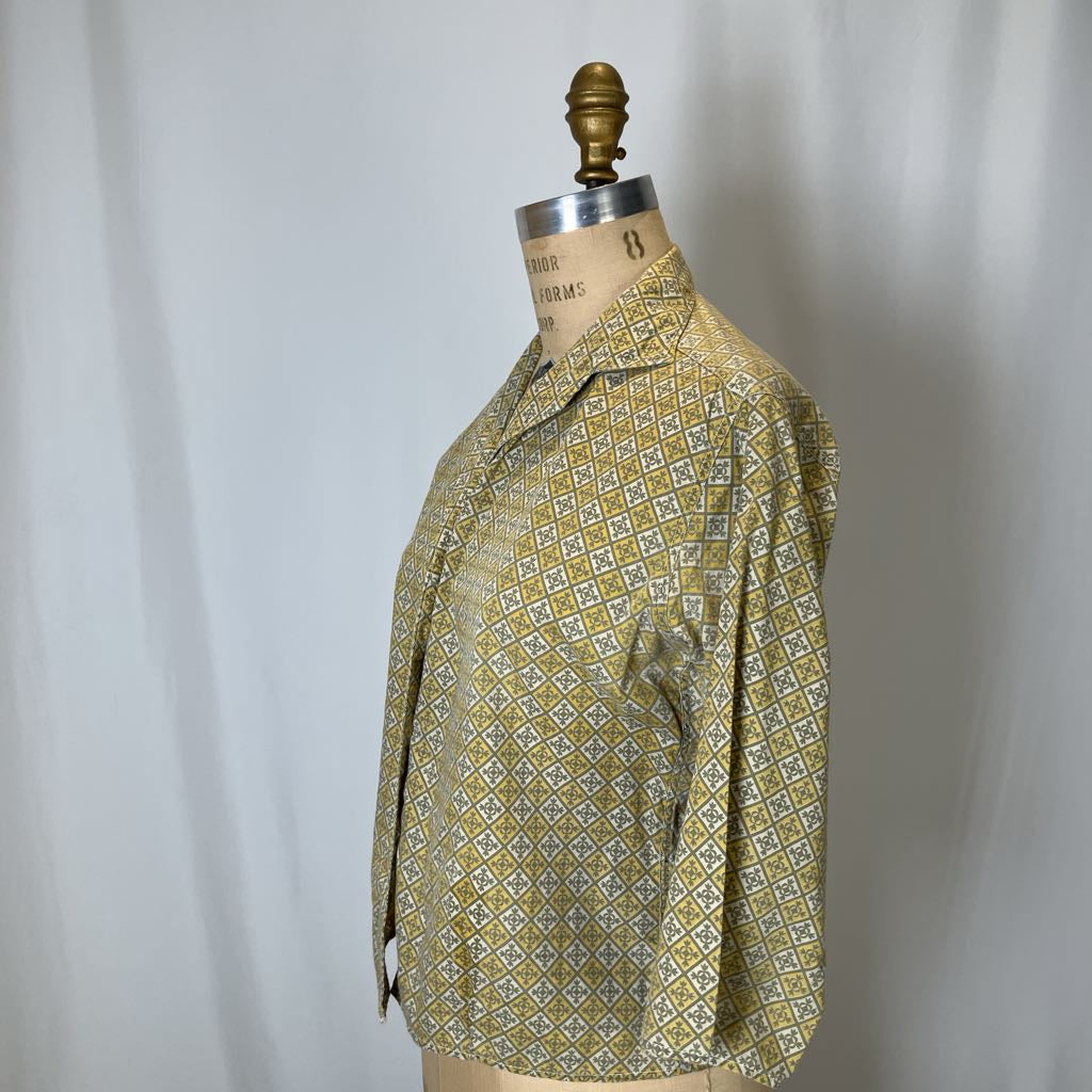 Vintage shirt on a mannequin against a plain background