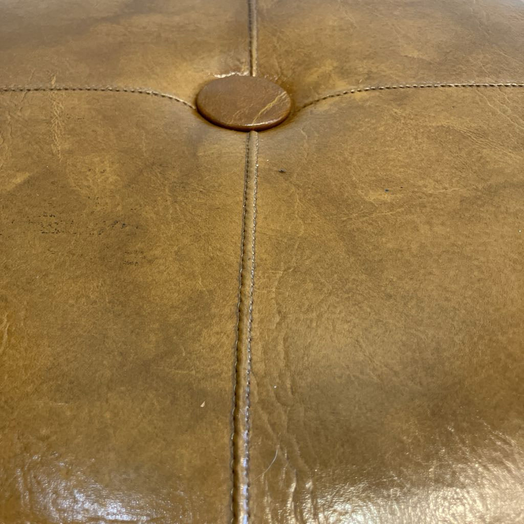 Close-up of brown leather surface with stitching detail