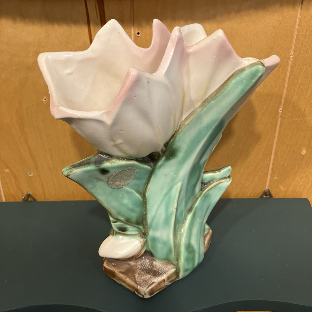 Ceramic tulip flower on a wooden background