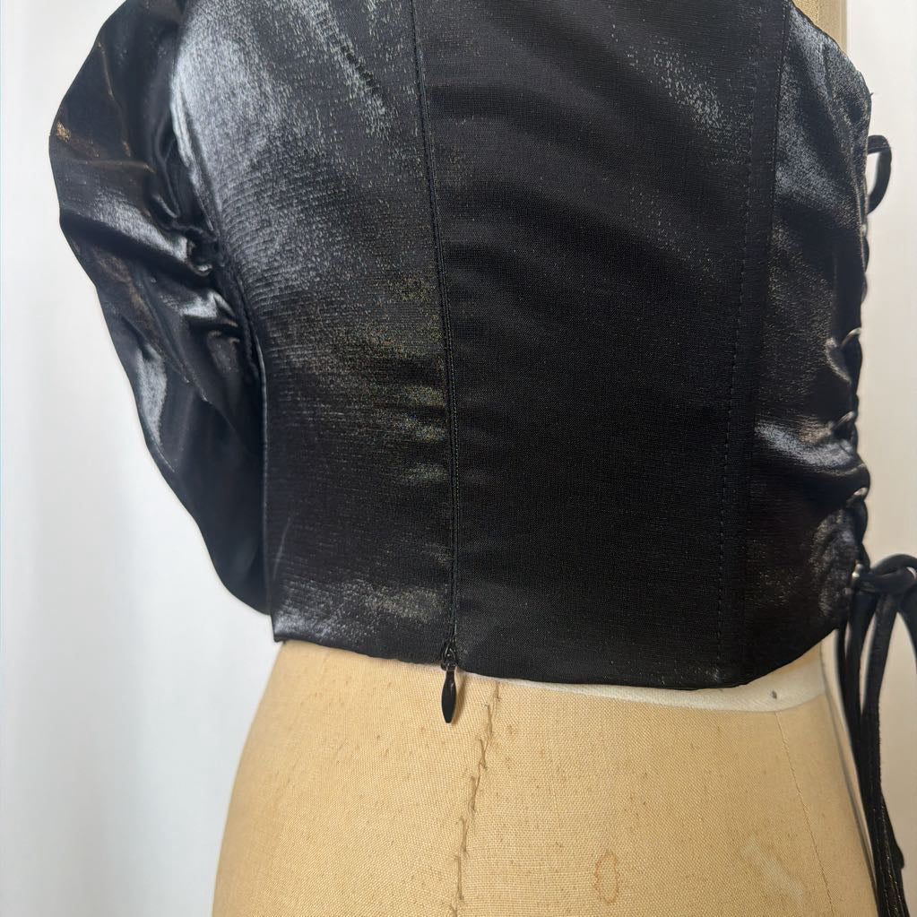 Photo of a black corset top with flower design on a mannequin against a white background