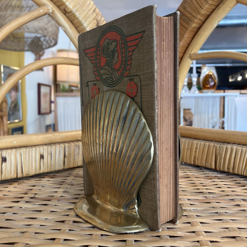Decorative bookend with shell design on a wicker surface