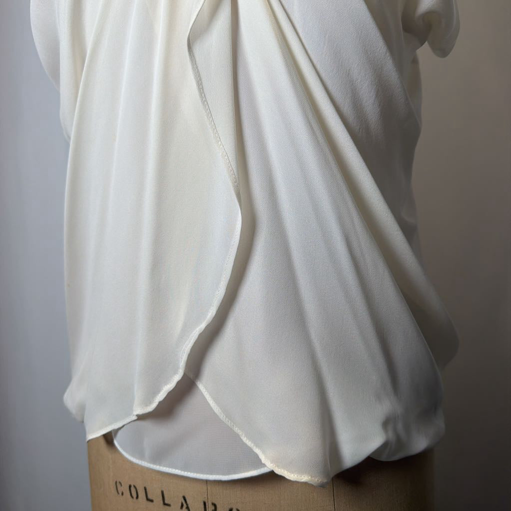 White blouse on a mannequin with a plain background