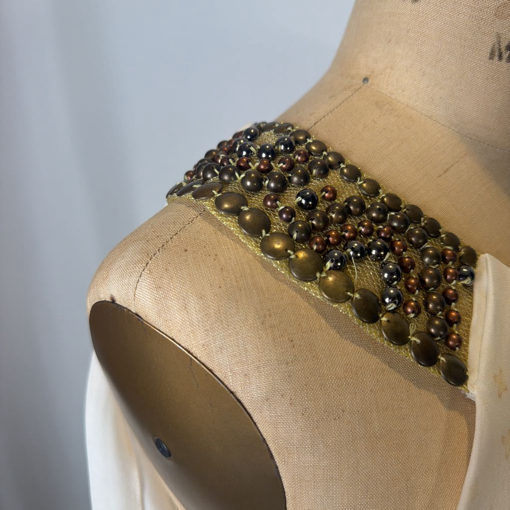 Beaded accessory on a mannequin with a plain background