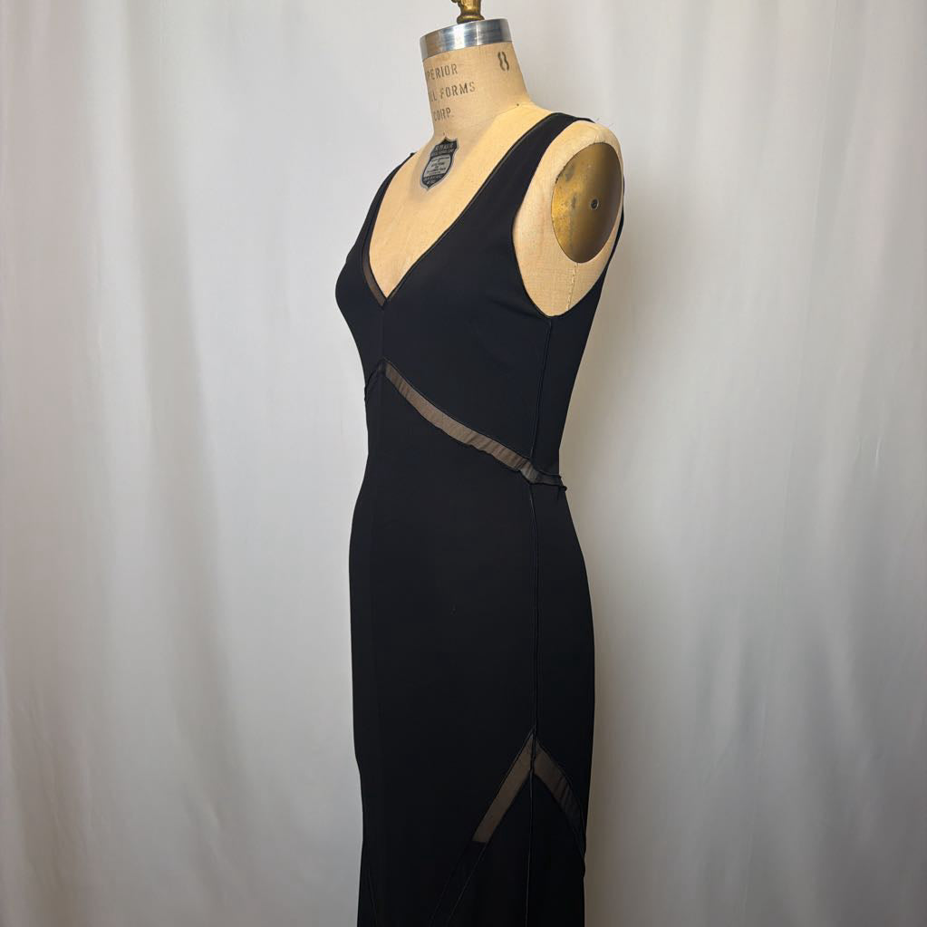 Black dress on a mannequin against a plain background