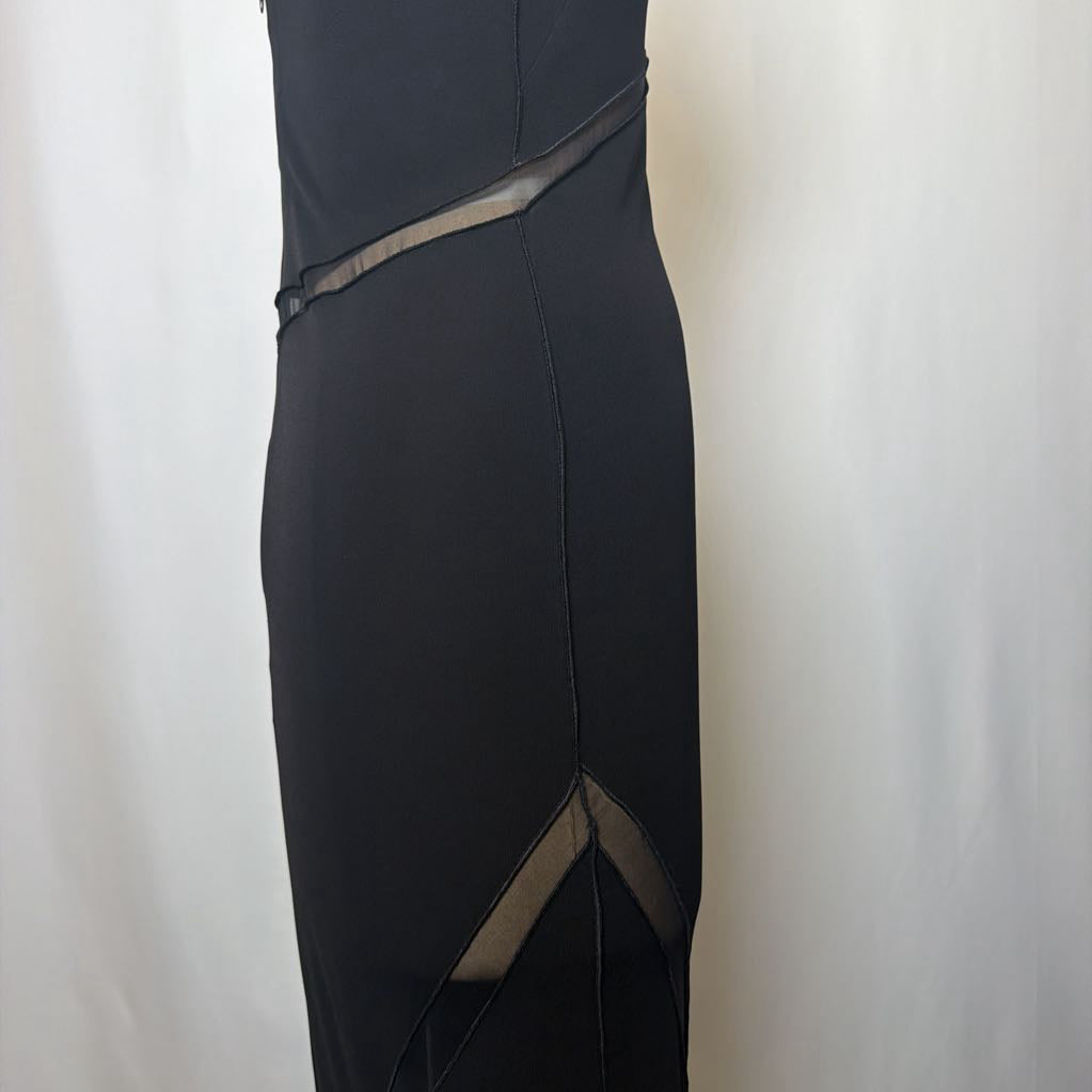 Black evening gown with sheer panels on a white background