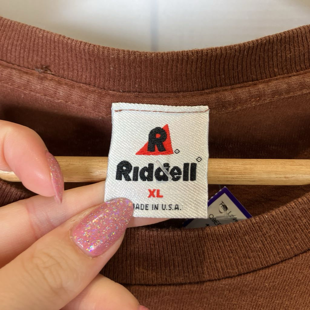 Riddell label on a brown item with a hand holding it