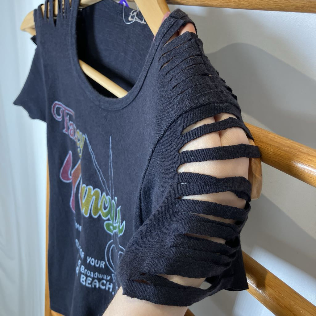 Black t-shirt with cut-out sleeves on a hanger