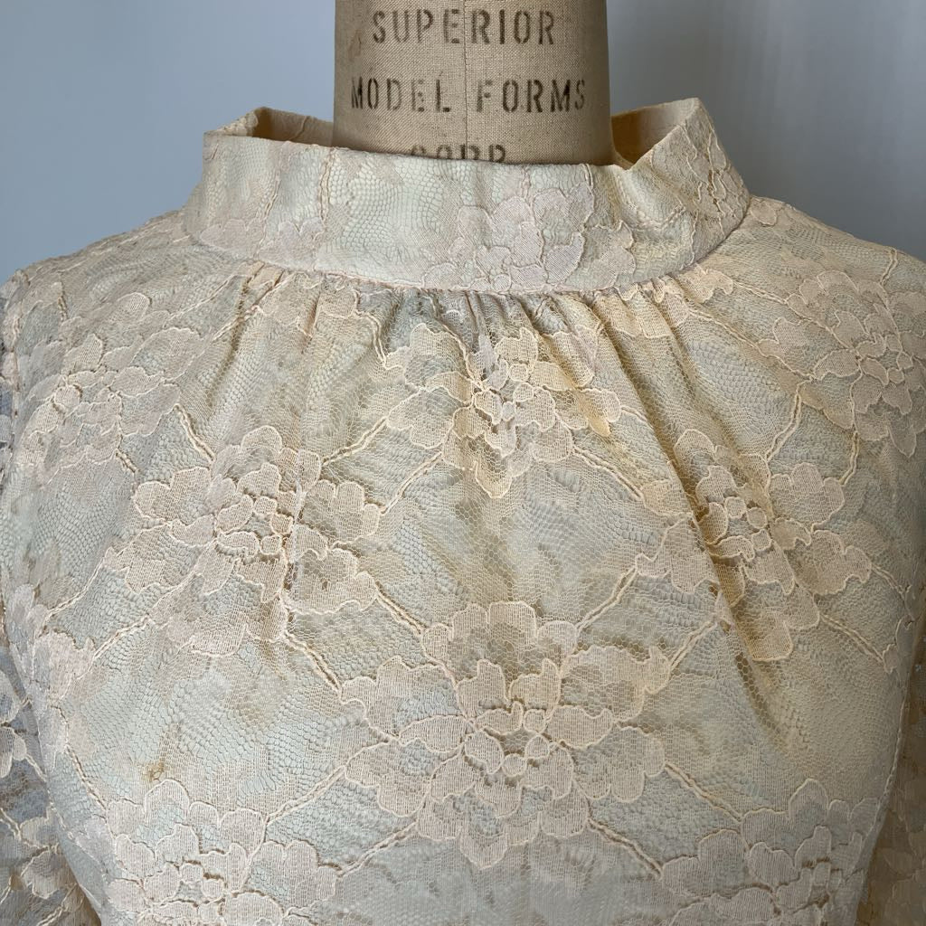 Lace garment on a mannequin with 'Superior Model Forms' label in the background