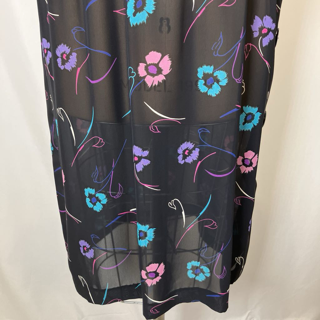 Black sheer curtain with colorful floral patterns on a white background