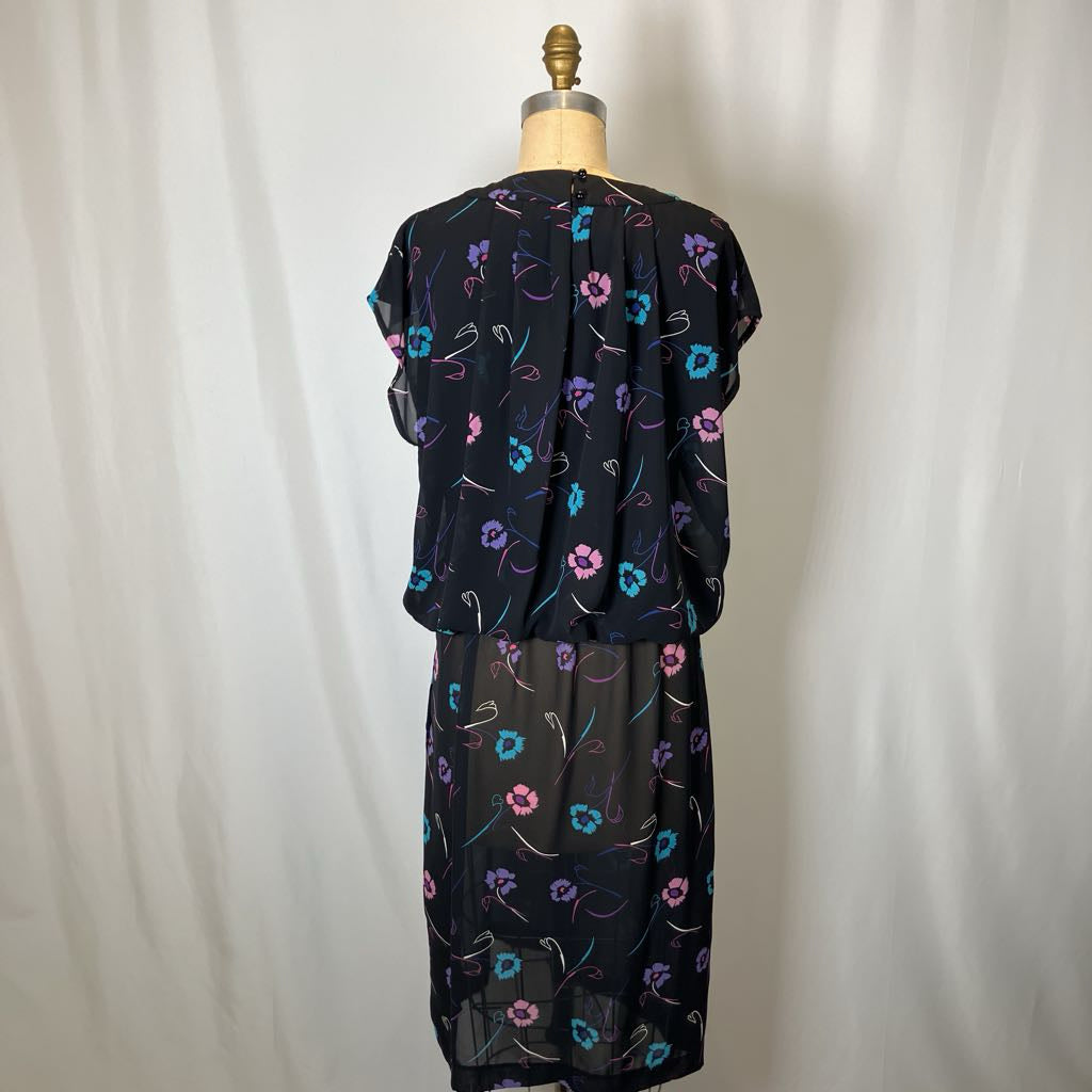 Black floral dress on a mannequin against a white background