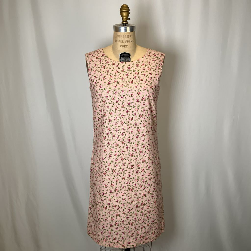Floral dress on a mannequin against a plain background