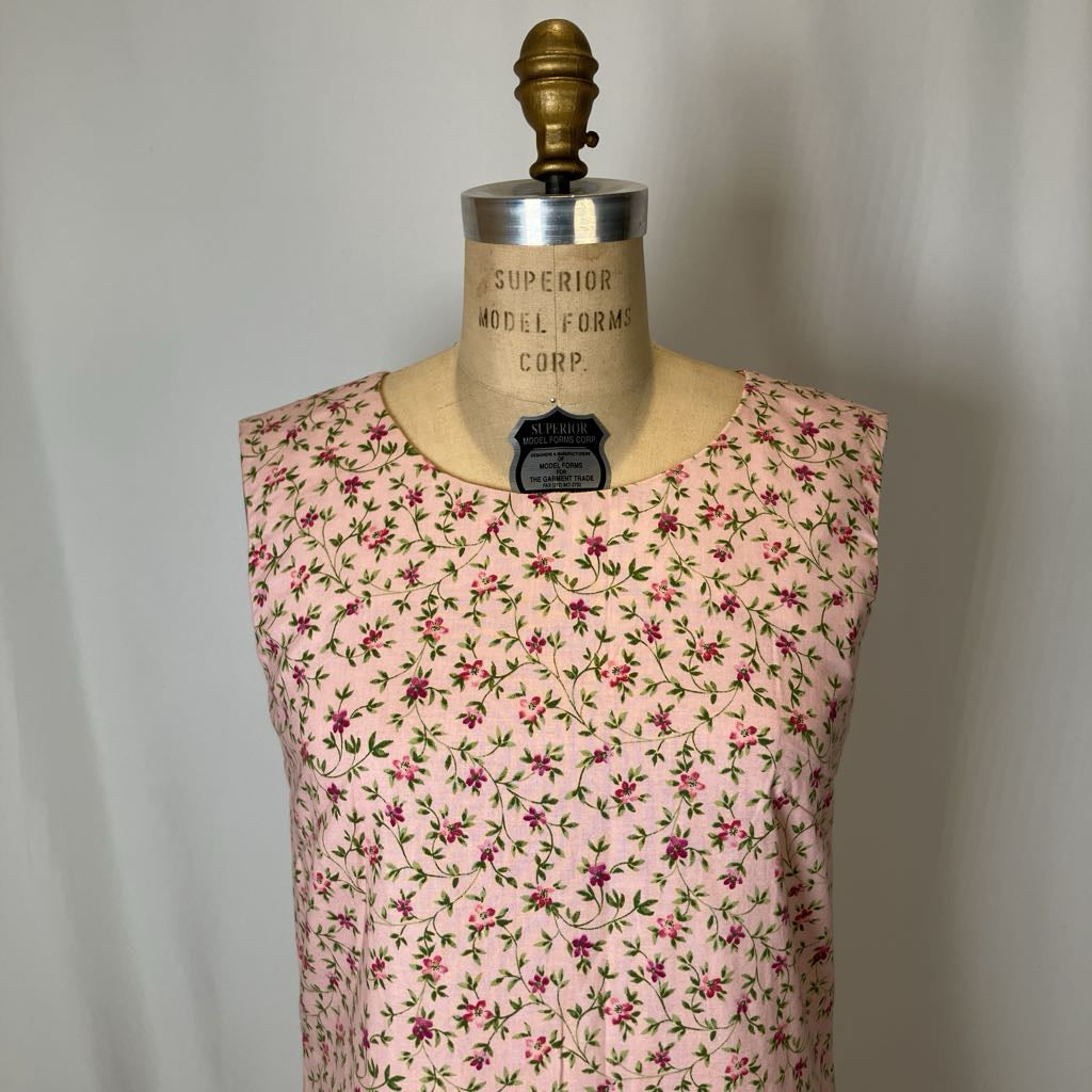 Mannequin wearing a pink floral dress against a plain background