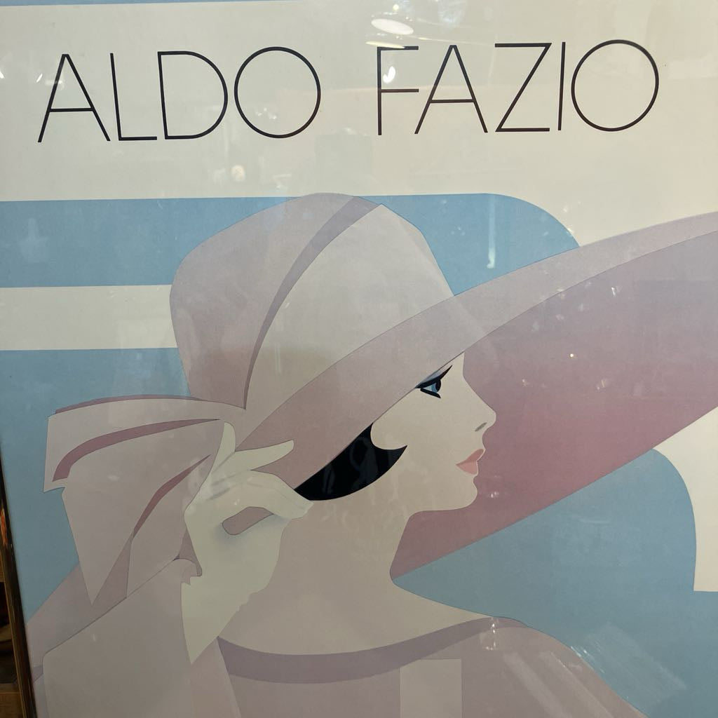 Advertisement for Aldo Fazio with a woman wearing a large hat on a blue background
