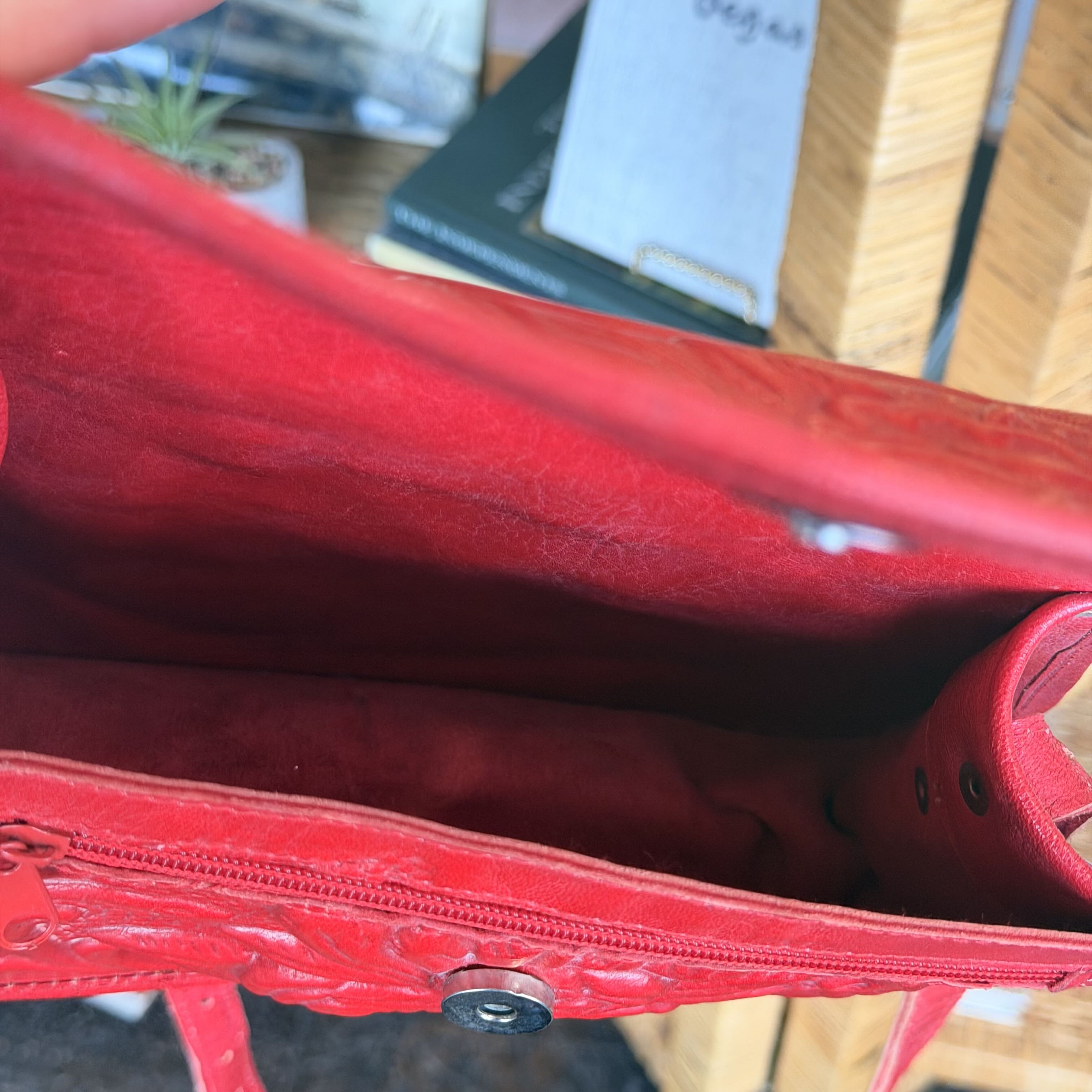 Close-up of a red handbag with a blurred background