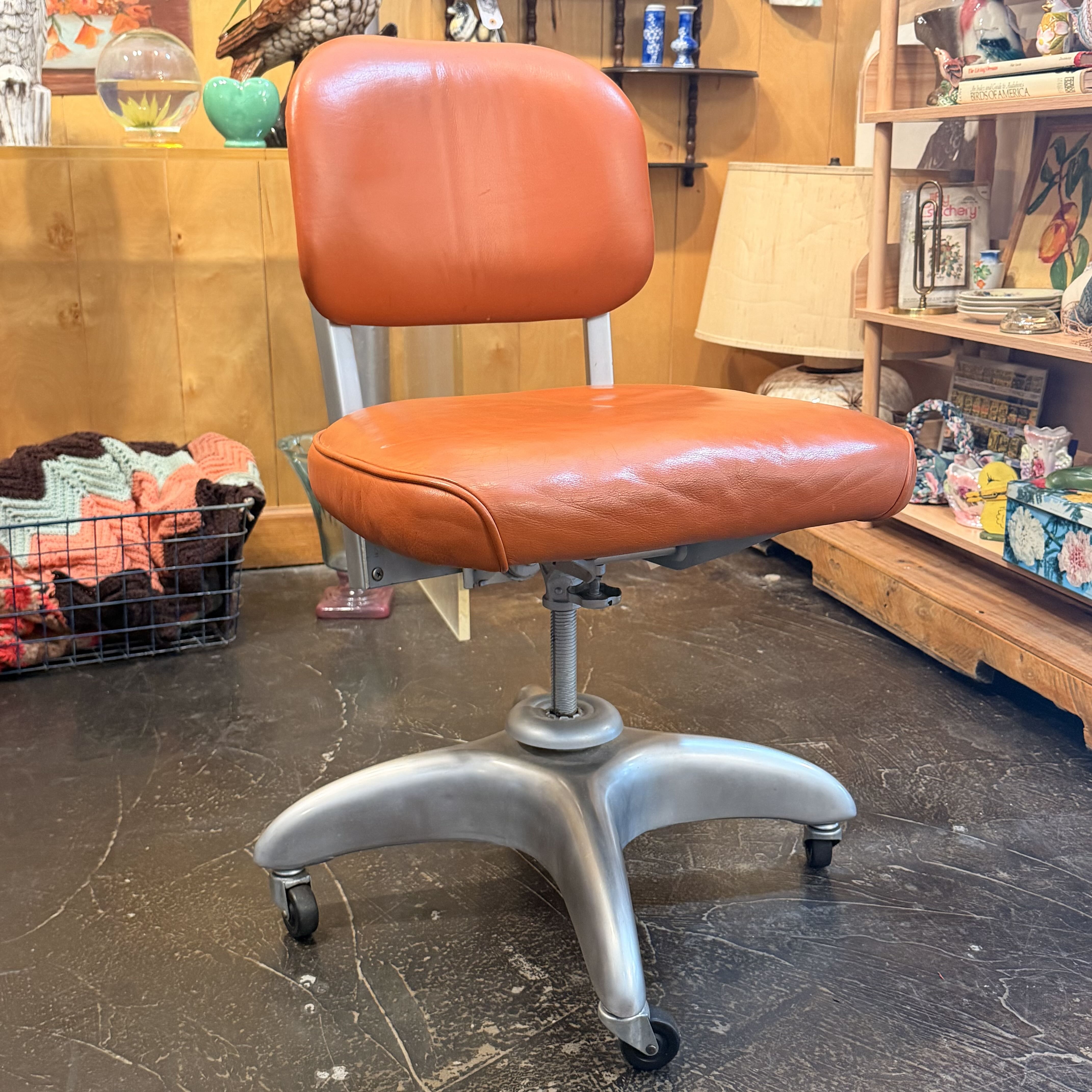 Orange chair with silver metal legs