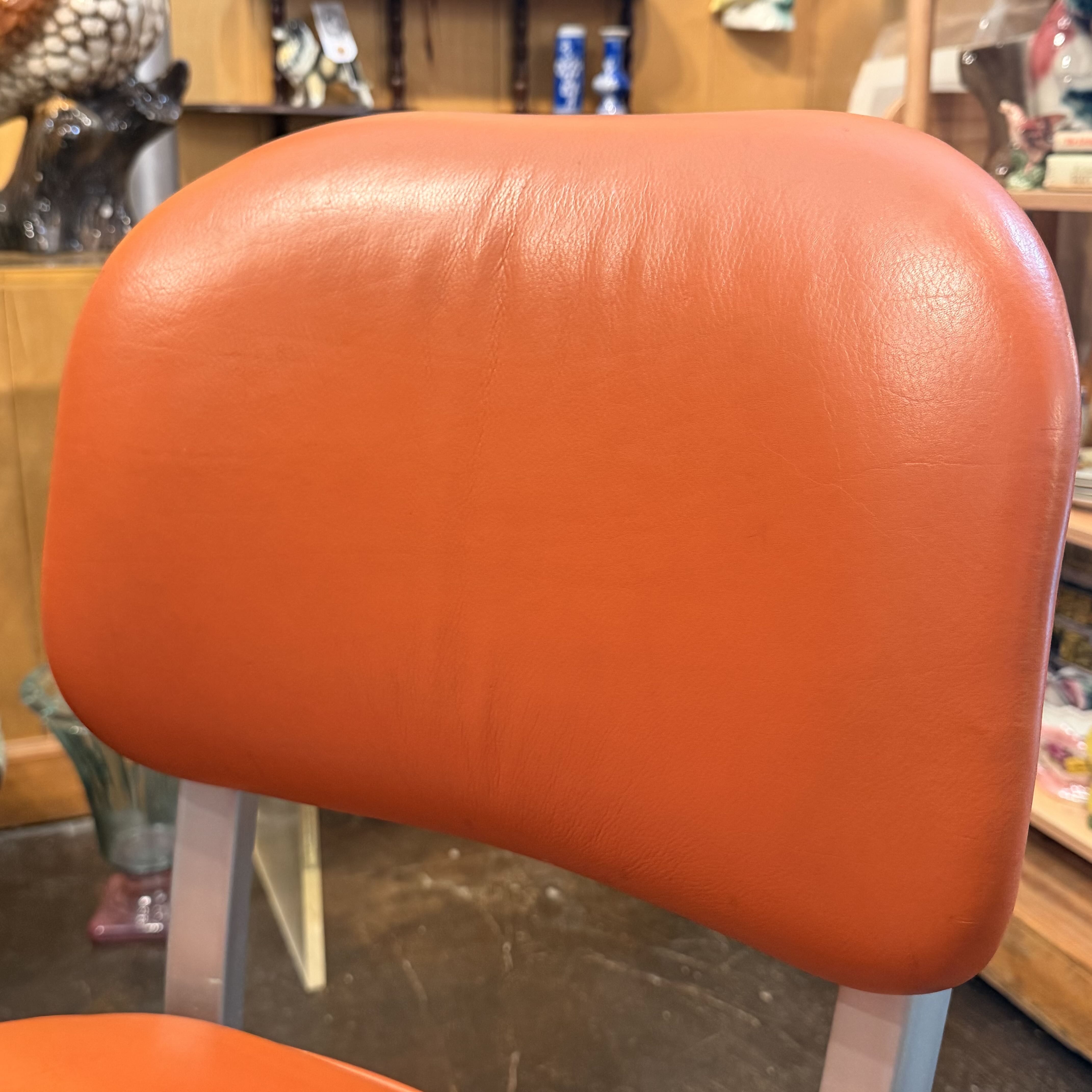 Orange chair with metal silver detailing