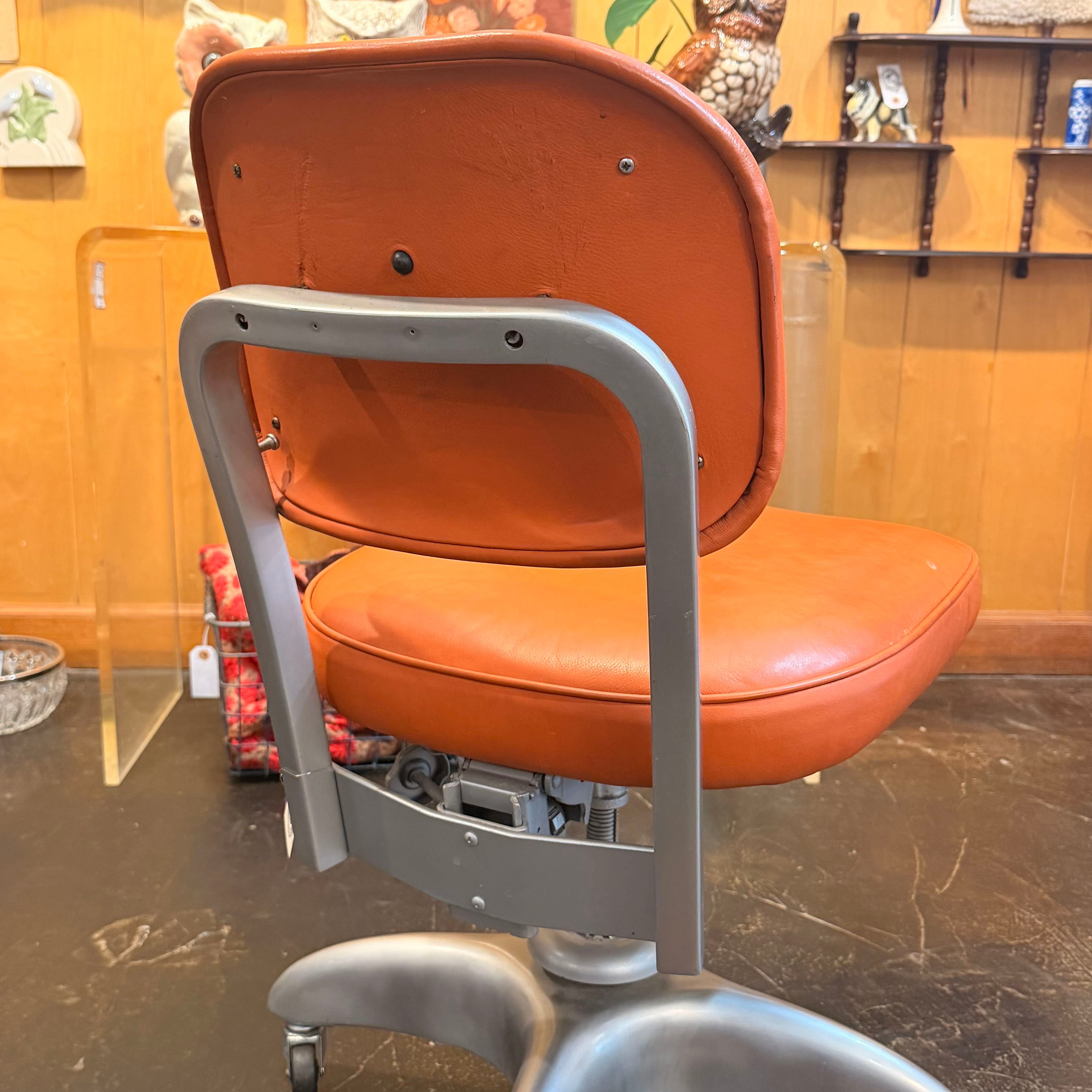 back of Orange chair with metal silver detailing