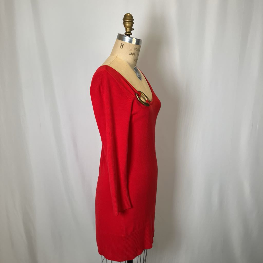 Red dress on a mannequin against a plain background