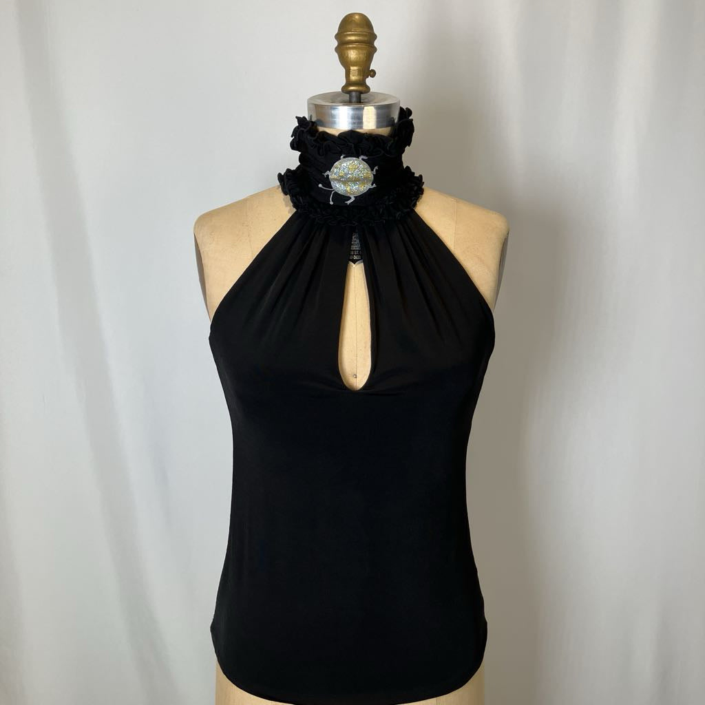 Black halter top on a mannequin against a plain background
