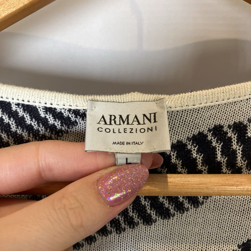Armani Collezioni label on a garment with a hand holding it.