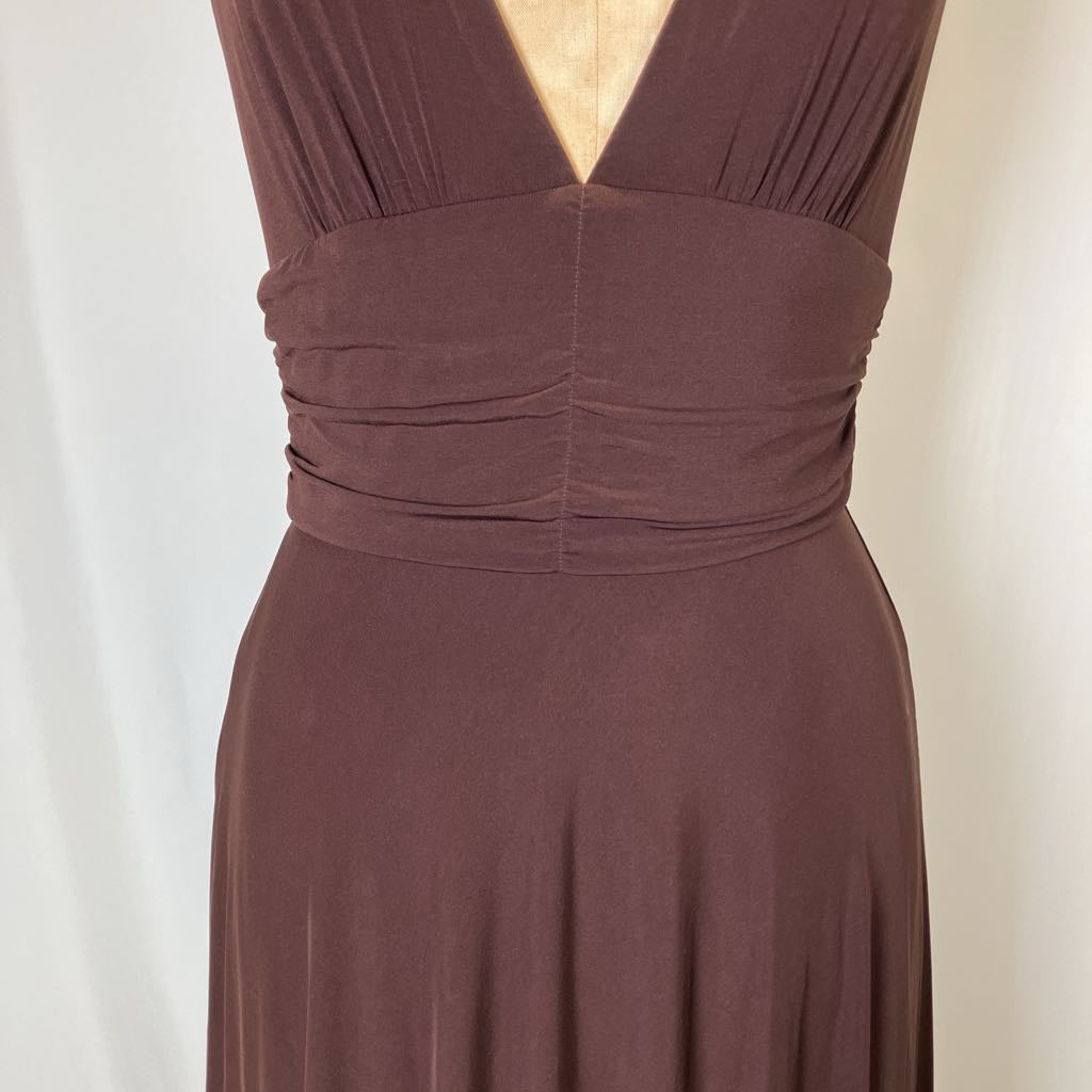 Brown dress with a plunging neckline on a neutral background