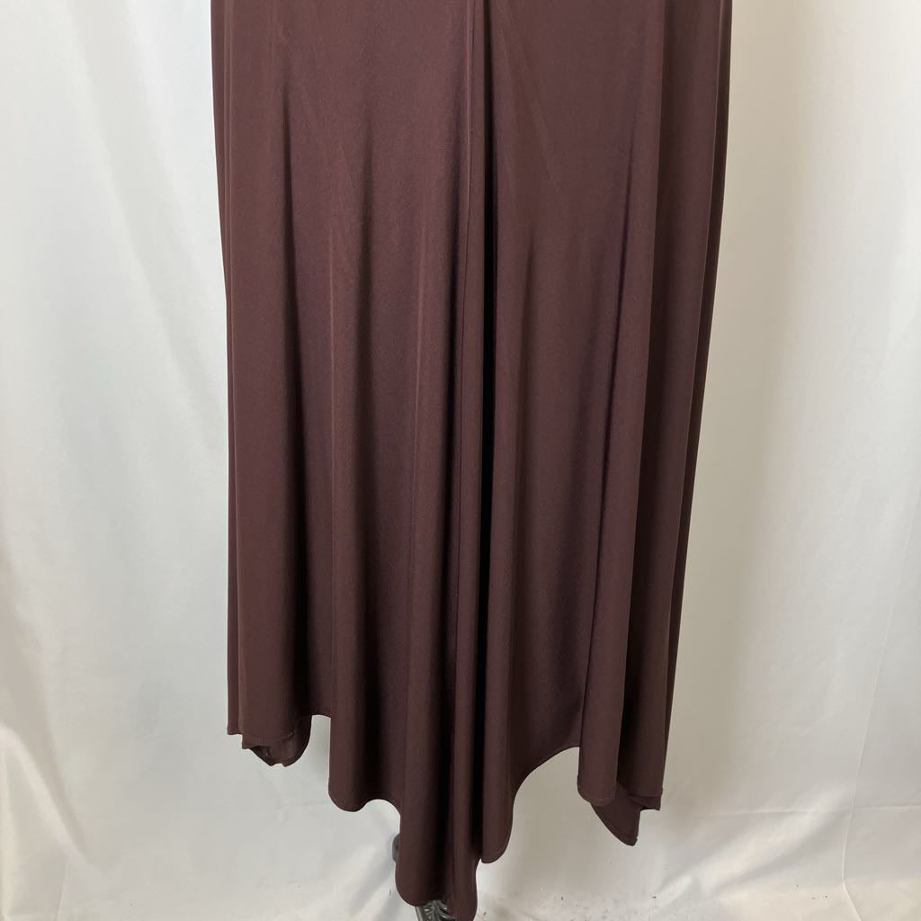 Brown skirt hanging against a white background