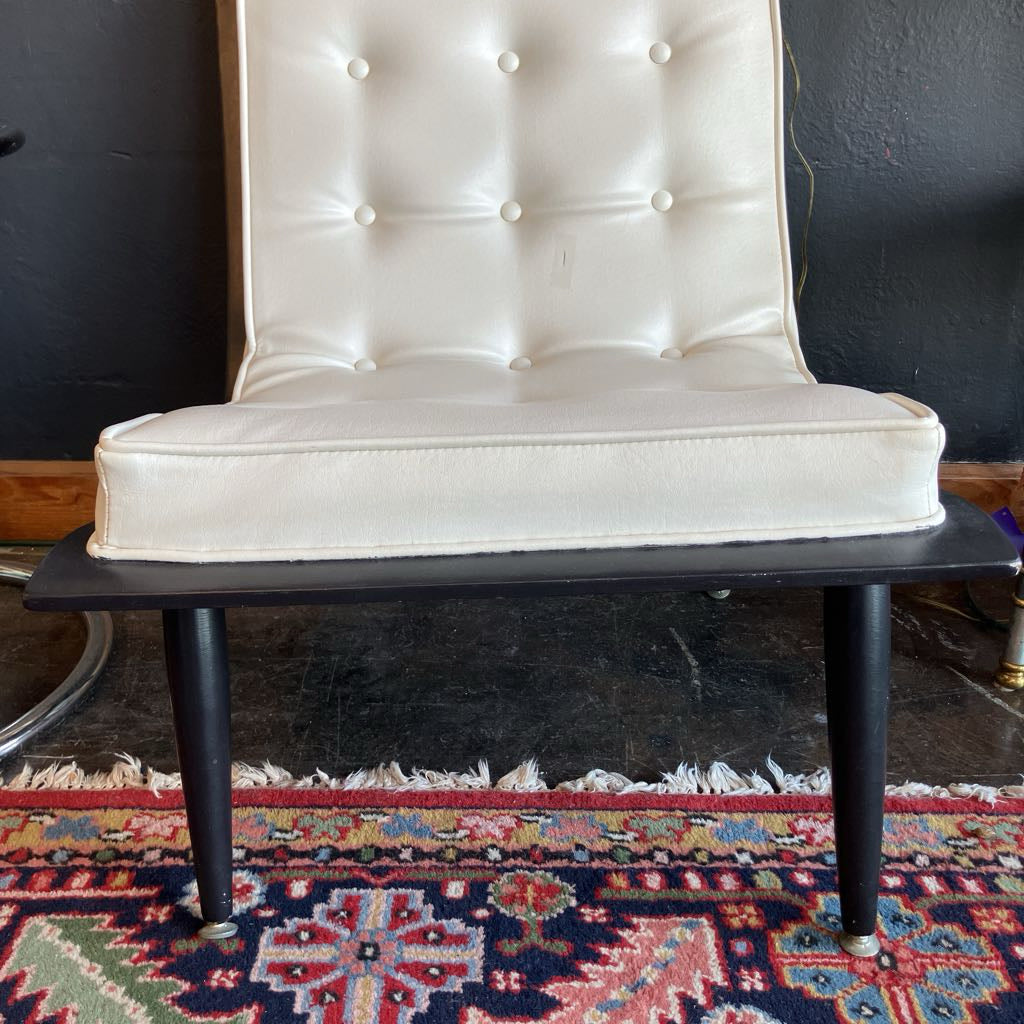 White mcm tufted vinyl scoop chair with walnut wood frame that has been painted black