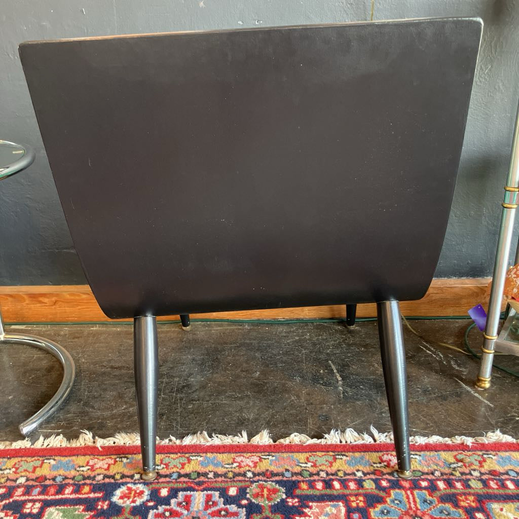 Show the walnut back of the chair that has been painted black