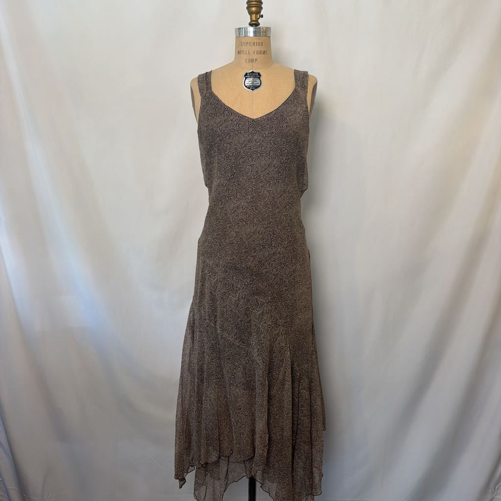 A sleeveless brown silk dress displayed on a dress form mannequin against a white fabric backdrop.
