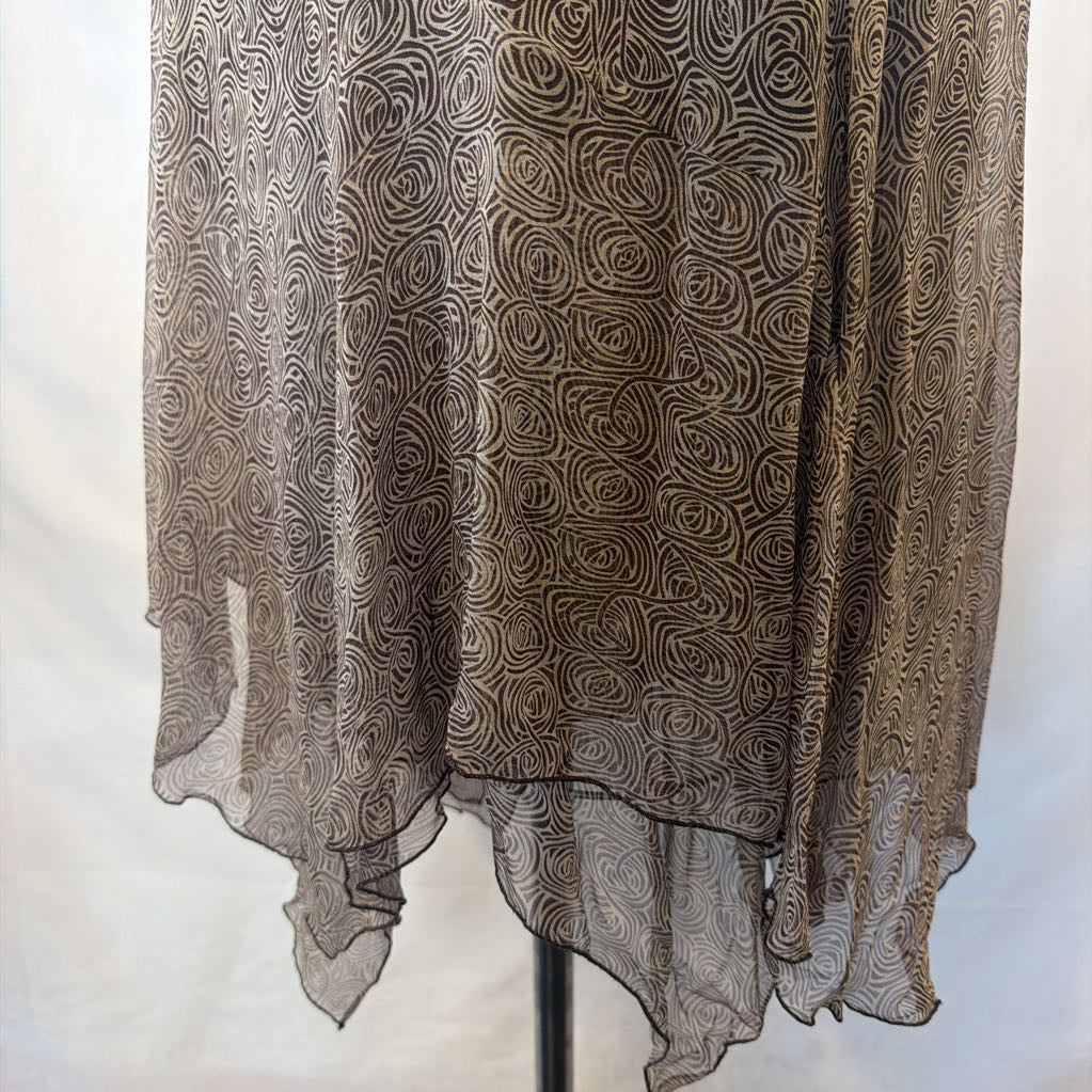 A sheer, lightweight fabric garment or drape with an all-over swirling abstract pattern in taupe, brown, and beige tones, hanging against a plain light background.